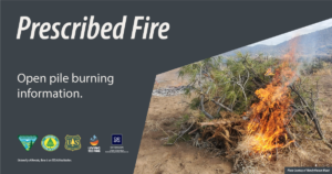 Photo of a pile of vegetation burning with text that says, "Prescribed fire. Open pile burning information."